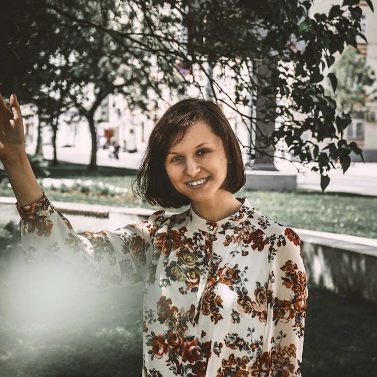 Avery Singh, Lead Design Curator at Verdant & Vine, reviewing corporate floral arrangements